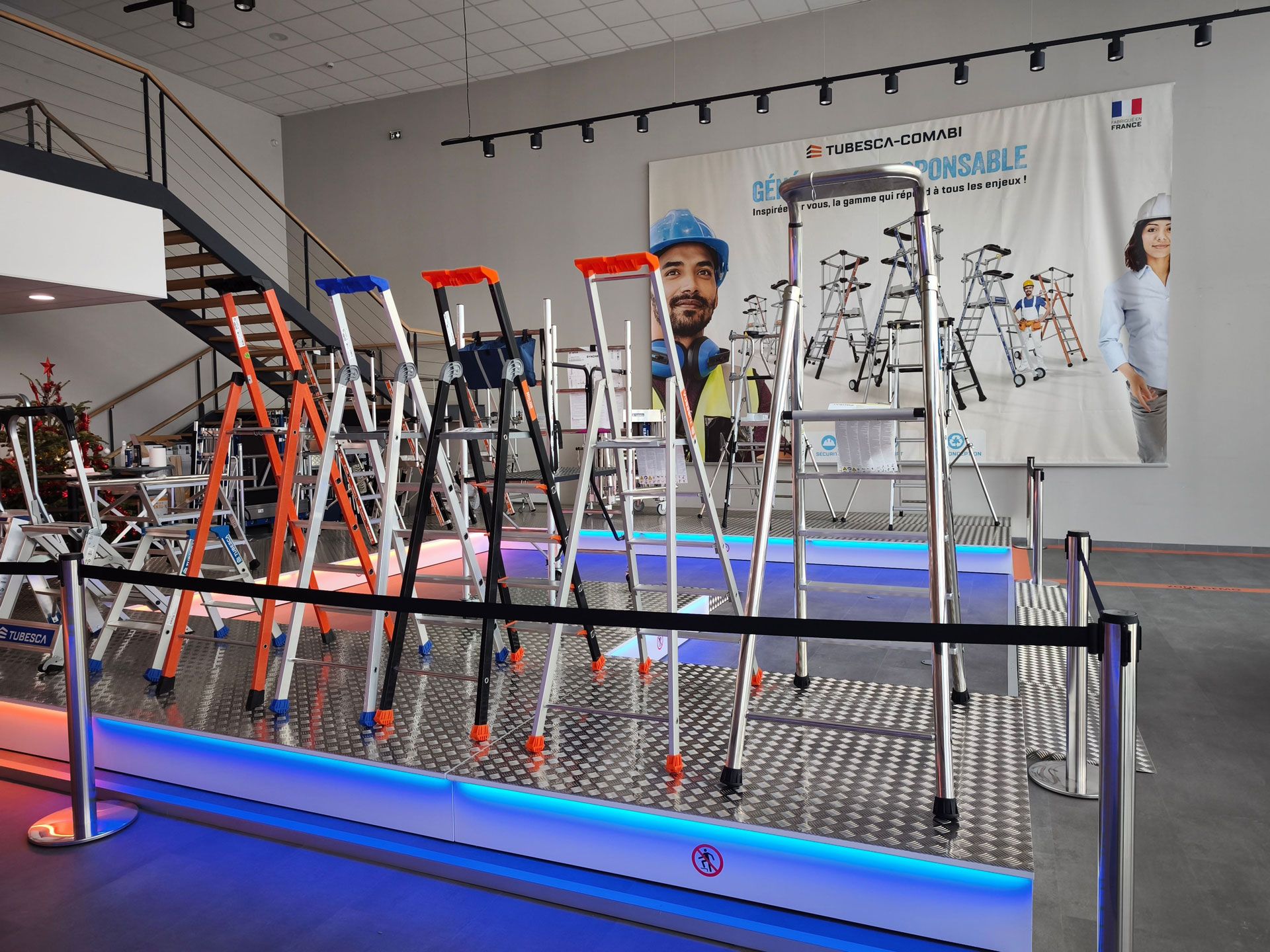 A showroom features a diverse display of colorful step ladders and stools.