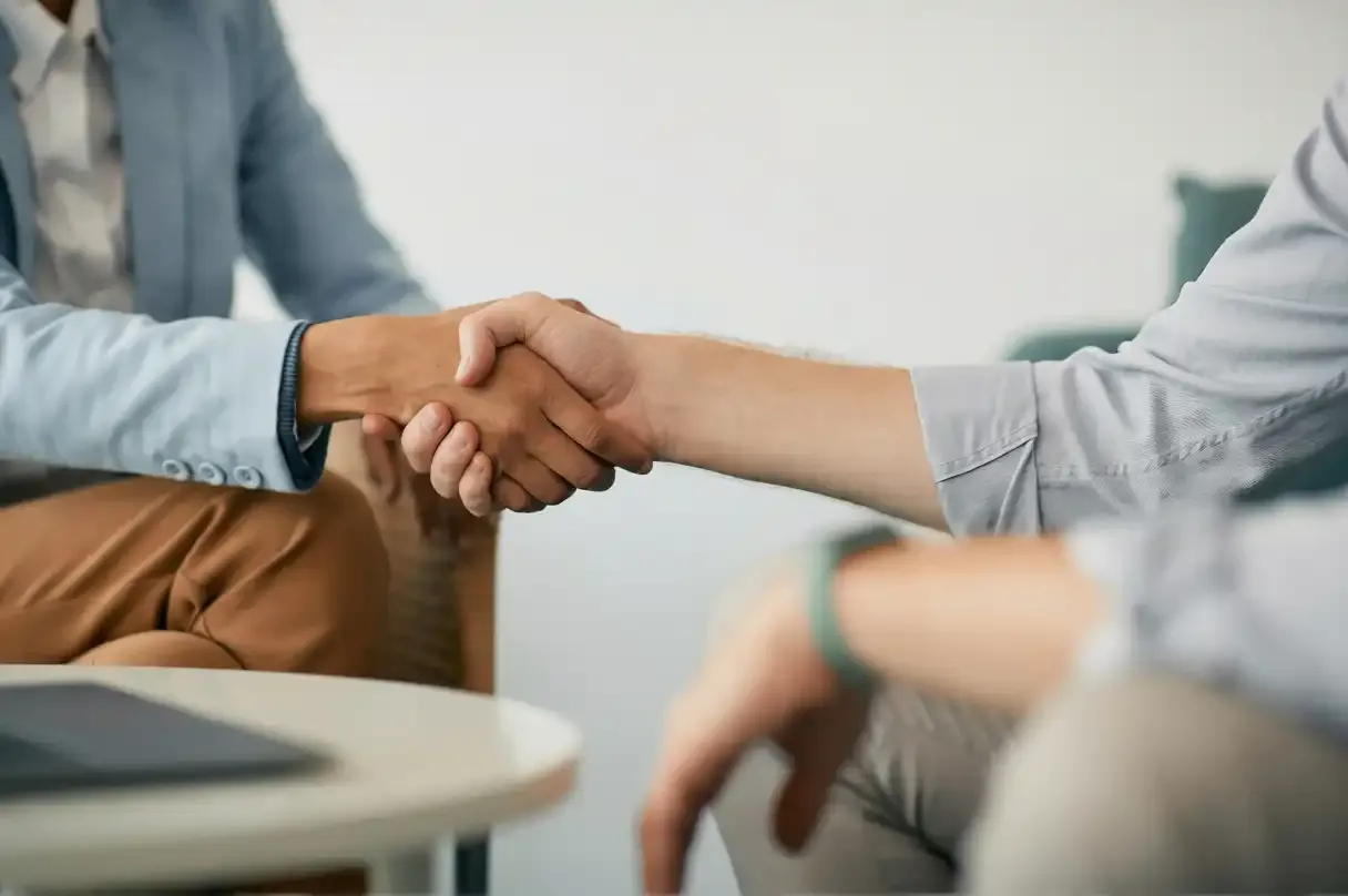 Two professionals shake hands, signifying agreement and the start of a new collaboration.